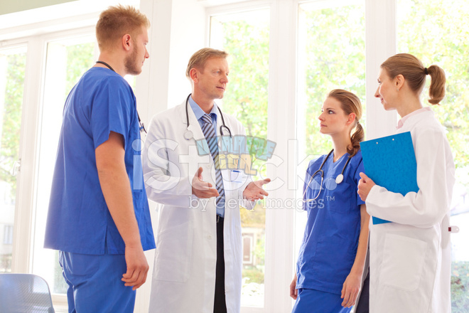 22275099-chief-doctor-speaking-to-his-team.jpg