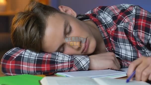 depositphotos_236966632-stock-video-tired-schoolboy-sleeping-table-preparation.jpg