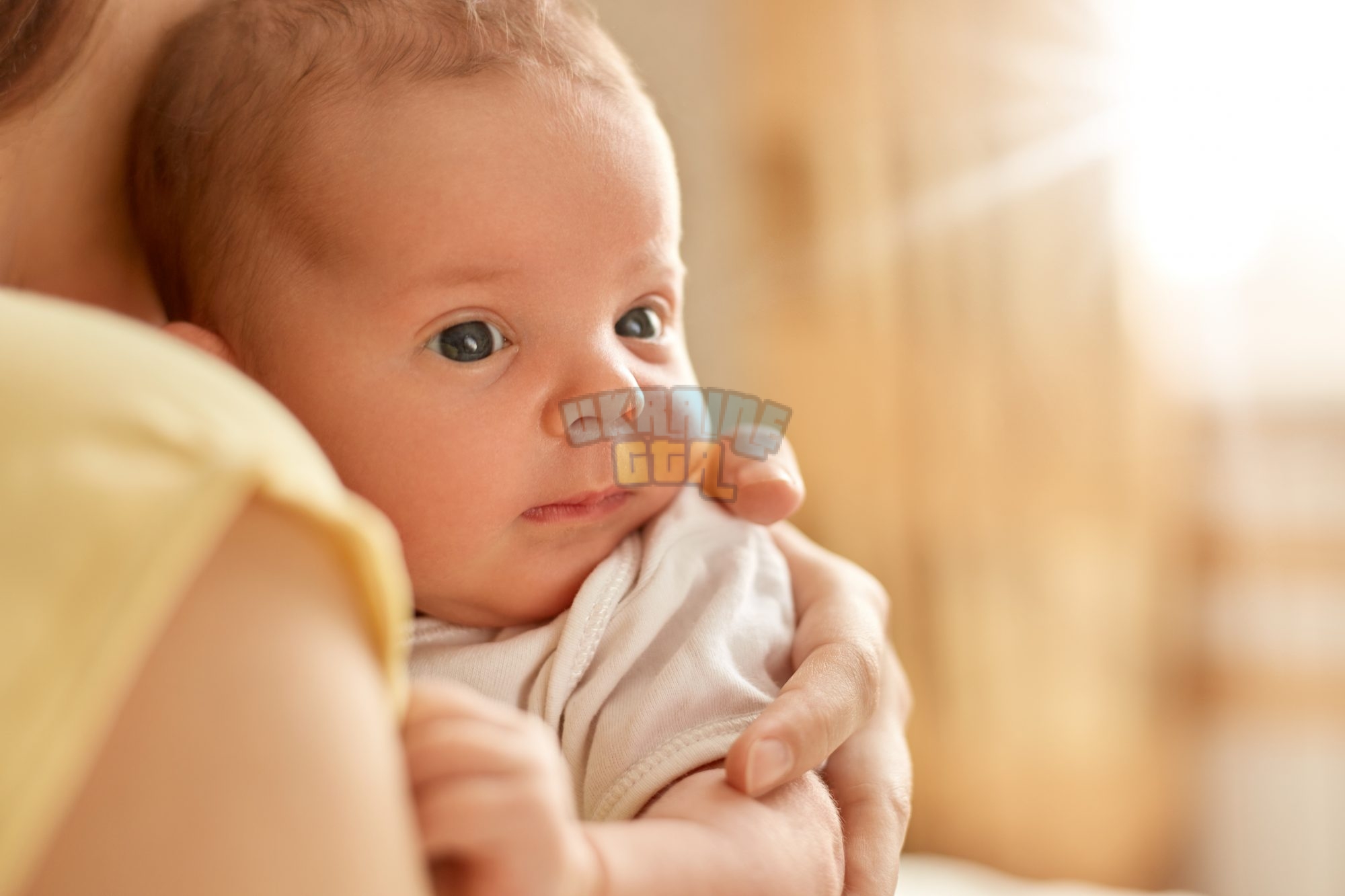 newborn-baby-her-mothers-arms-looking-away-studying-outward-things-faceless-mum-with-child-ind...jpg